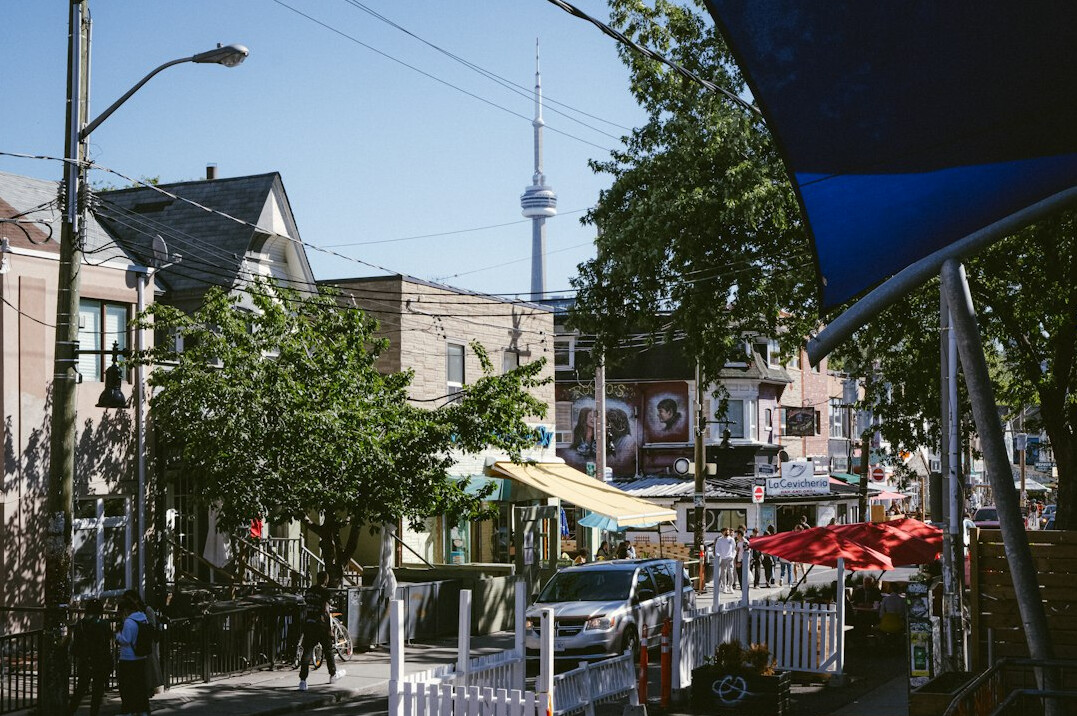 Colorful storefronts and market stalls in Toronto's Kensington Market neighborhood